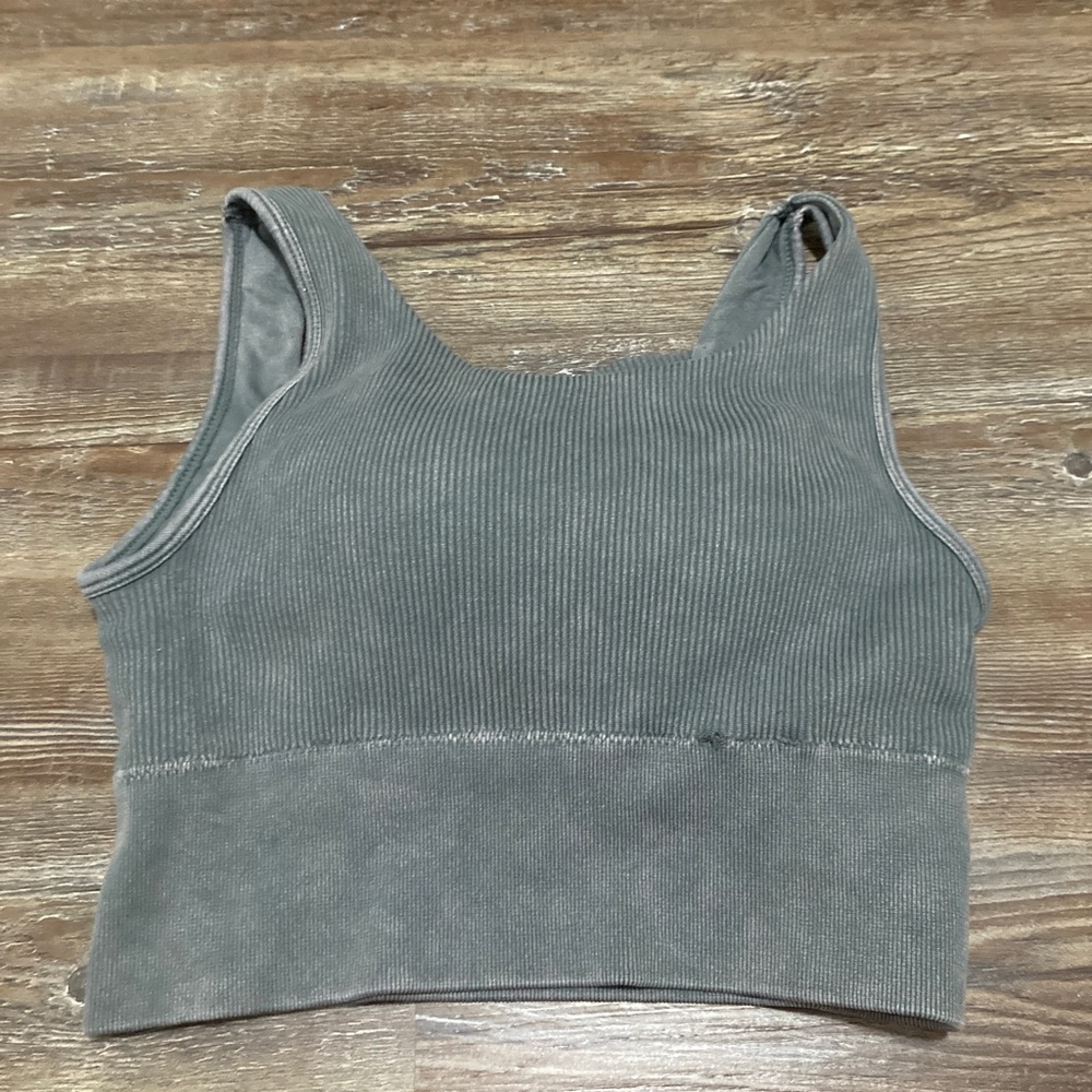 I’m selling this blueish-grey top that is cropped and padded and has an athletic